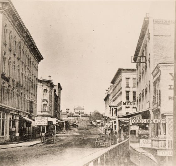 #41 View from along right side of bridge of Milwaukee Street looking east in Janesville, 1870
