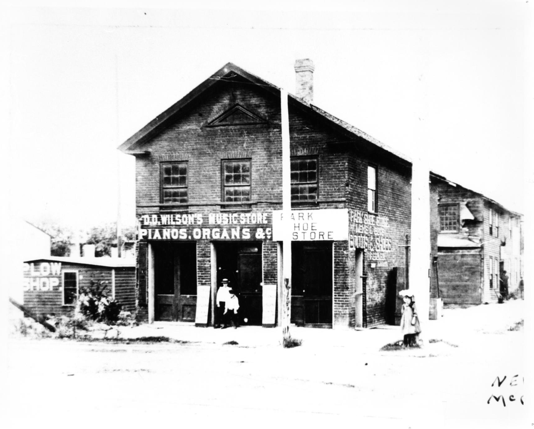 #61 D. D. Wilson’s Music Store and the Park Shoe Store, at the northwest corner of Court and Main Streets, 1870