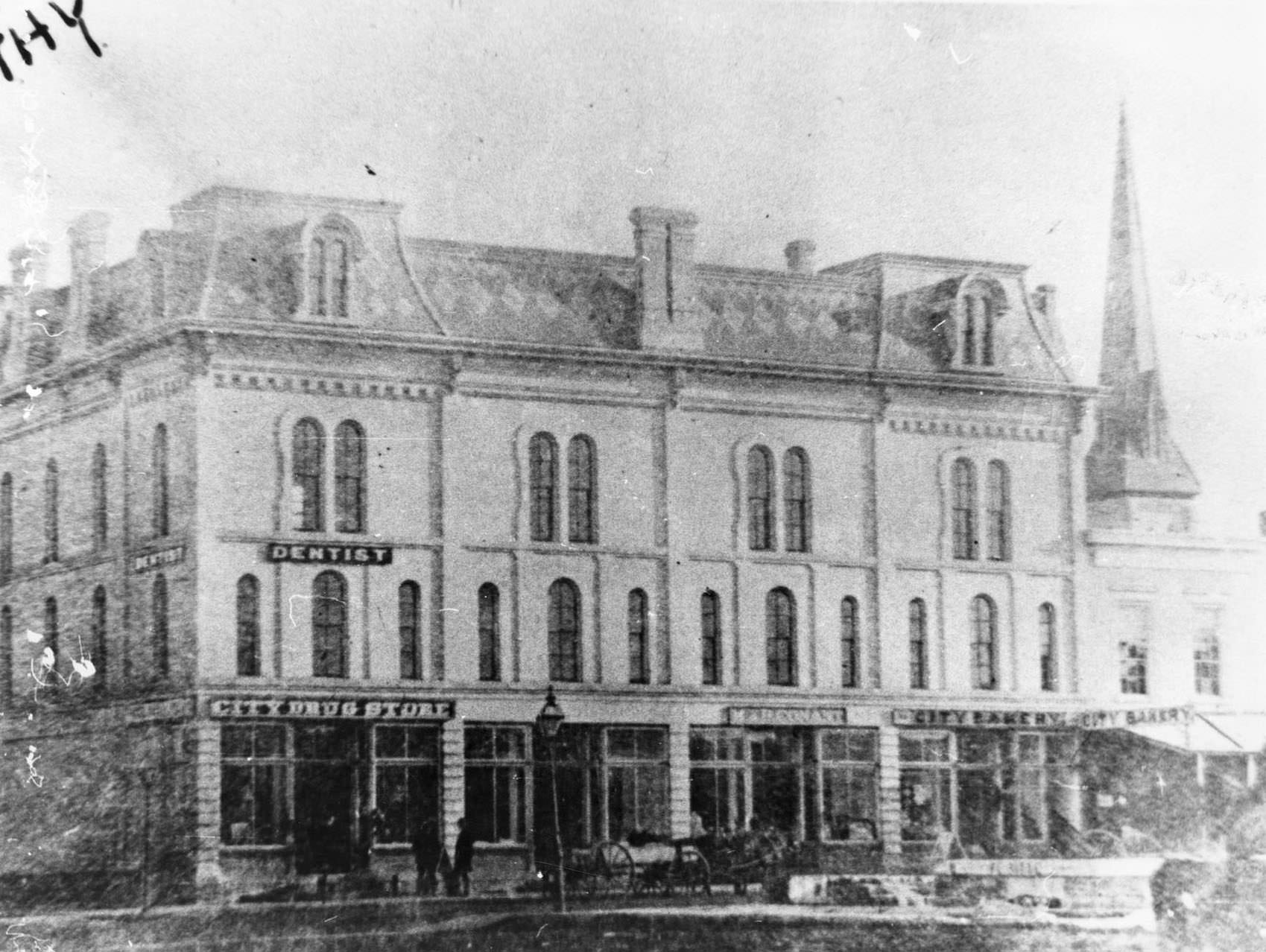 #76 A building with a mansard roof at the corner of Franklin and Milwaukee Streets in Janesville, 1890