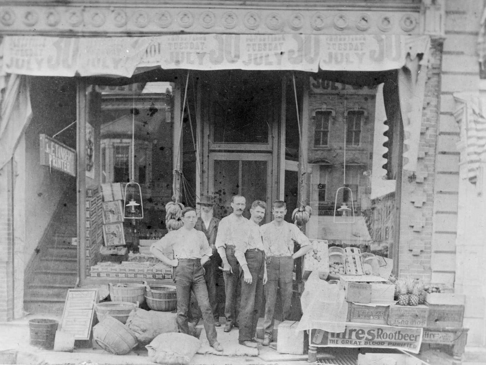 #86 Five men outside their grocery store on River Street in Janesville, 1890.