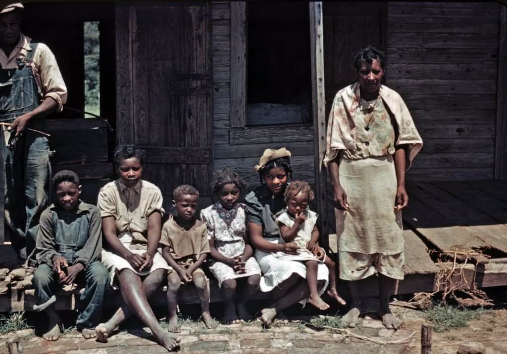#151 A family seated on the porch of a house at the Bayou Bourbeau Plantation, Louisiana, 1940