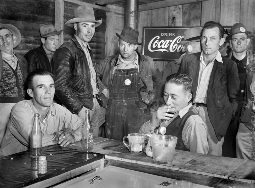 #192 Construction Workers from Camp Livingston U.S. Military Base eating and hanging around new Cafe, Alexandria, Louisiana, 1940