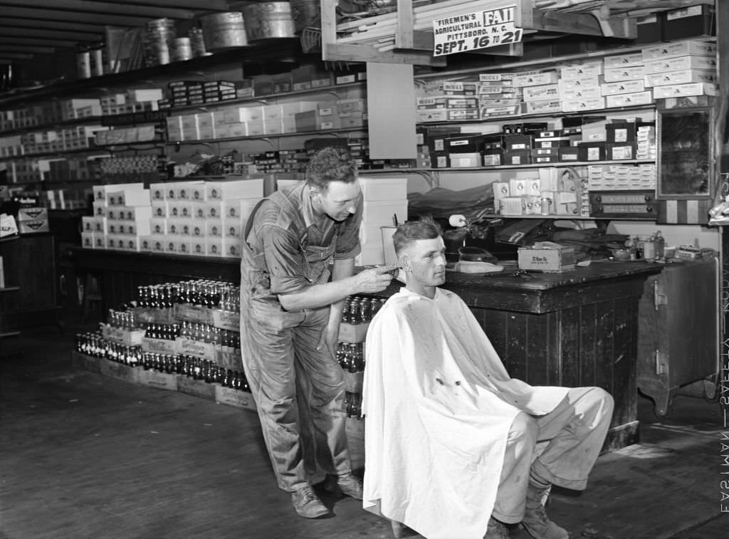 #195 Free haircut on Saturday morning in W.M. Scott’s general store. Farrington, Chatham County, North Carolina, September 1940
