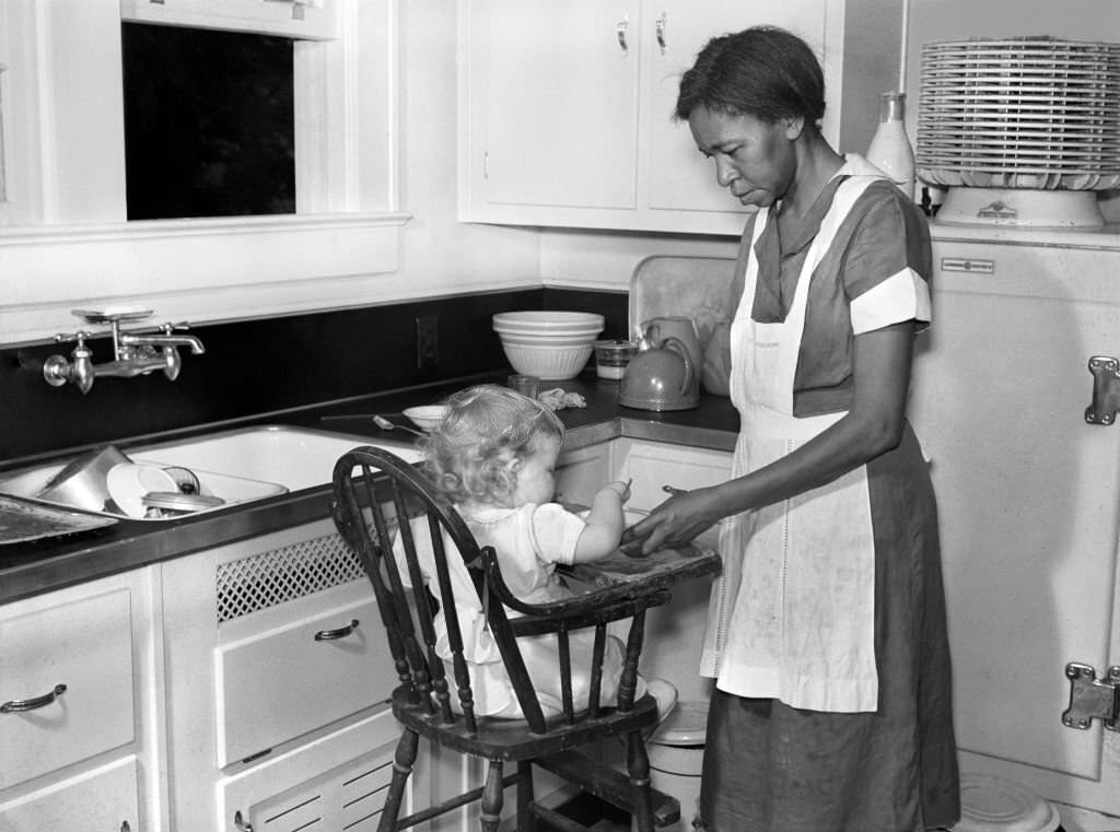 #214 Domestic Worker with Young Child in Kitchen, Atlanta, Georgia, 1939.