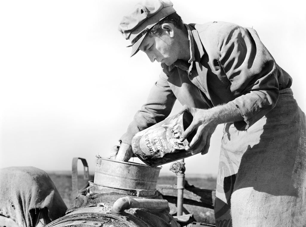 #48 Migrant Day Laborer mixing Spray to kill White Flies and nourish Bean Plants, near Belle Glade, Florida, 1939