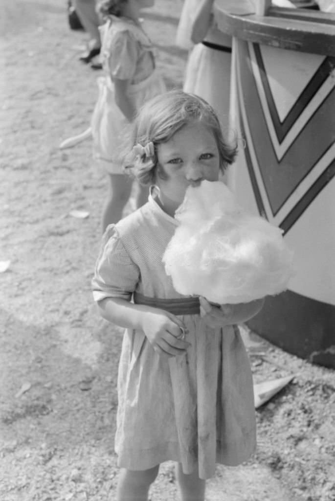 #60 Young Girl Eating Cotton Candy, Cotton Carnival, Memphis, Tennessee, May 1940
