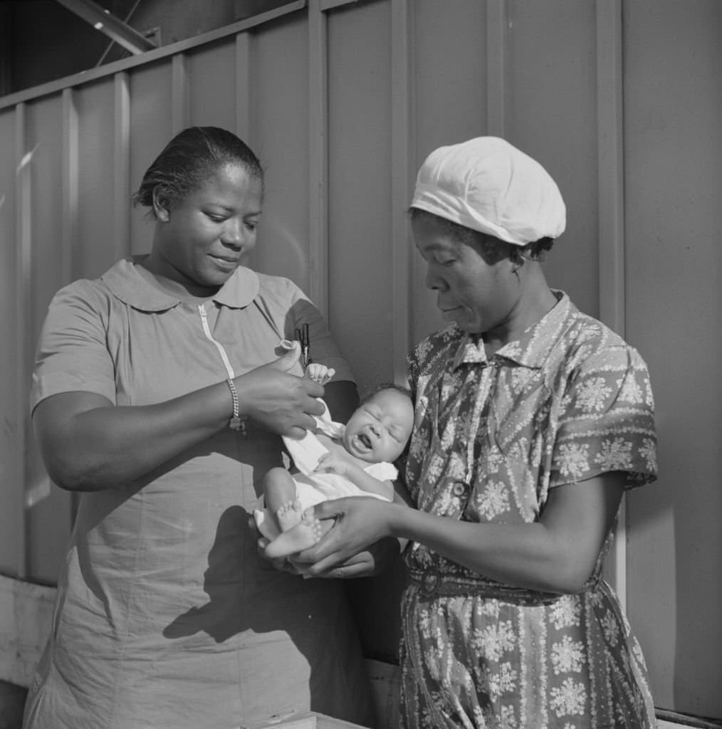 #61 Nurse Examining Infant with Mother and Child Receiving Prenatal and Postnatal Care, Florida, June 1940