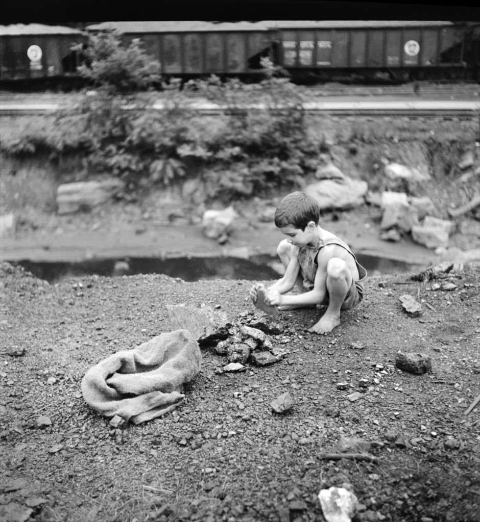 #63 Coal Miner’s Child breaking up large pieces of Coal to take home, Scotts Run, West Virginia, 1939