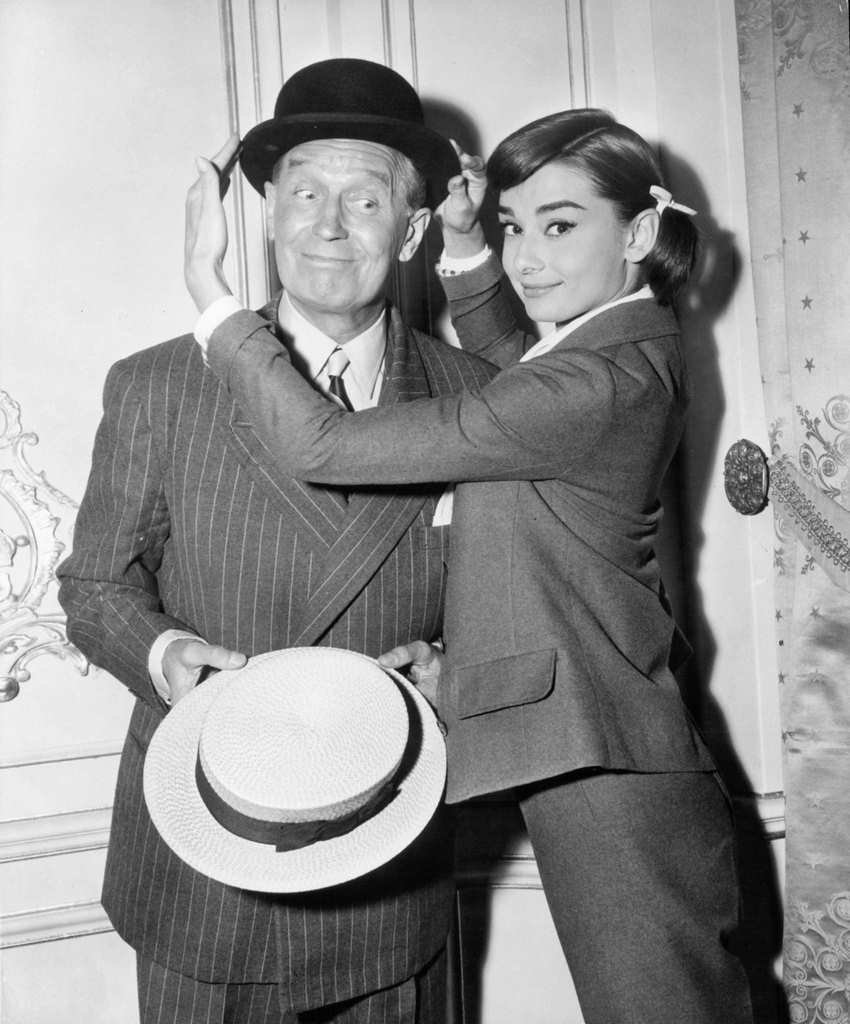 Maurice Chevalier has his hat adjusted by Audrey Hepburn in a scene from the film ‘Love In The Afternoon’, 1957.