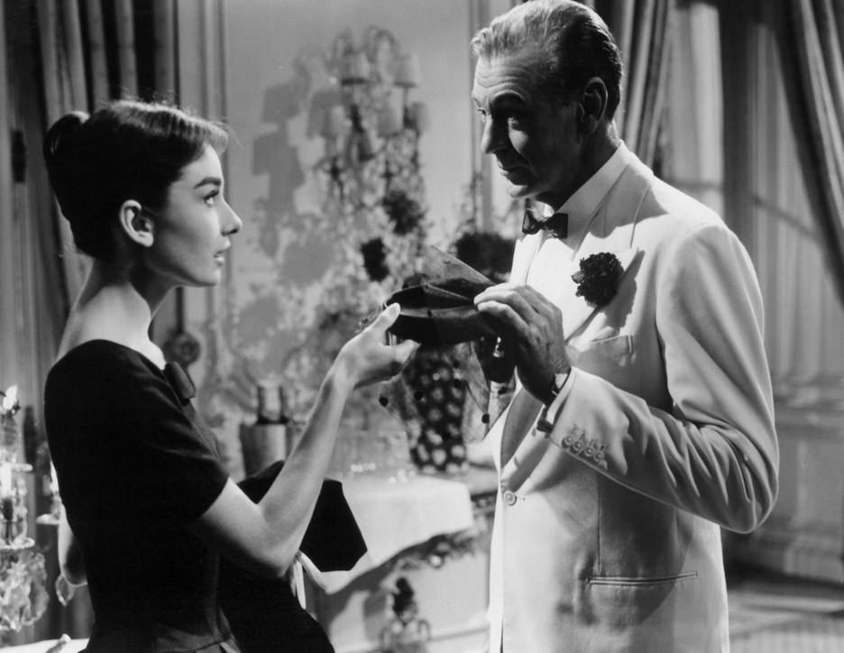 Audrey Hepburn and Gary Cooper holding woman’s cap in a scene from the film ‘Love In The Afternoon’, 1957.
