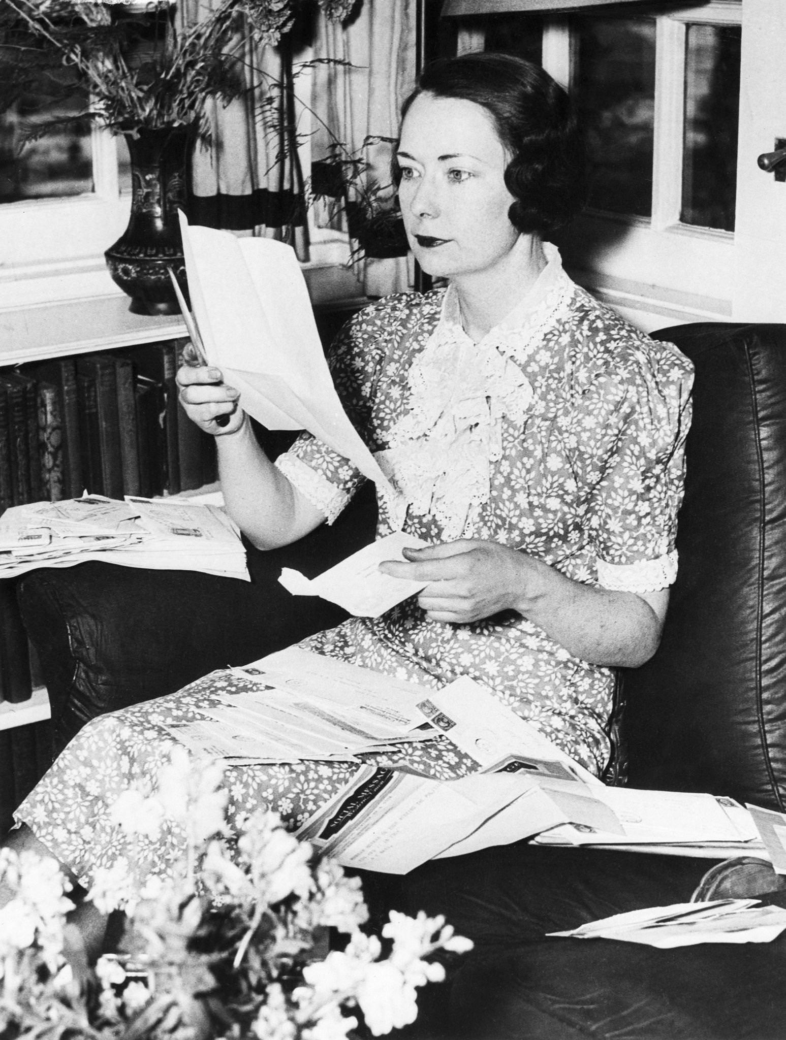 #3 Margaret Mitchell reads written and wired congratulations in her home in Atlanta, Georgia, following announcement that the novel had won the Pulitzer Prize.