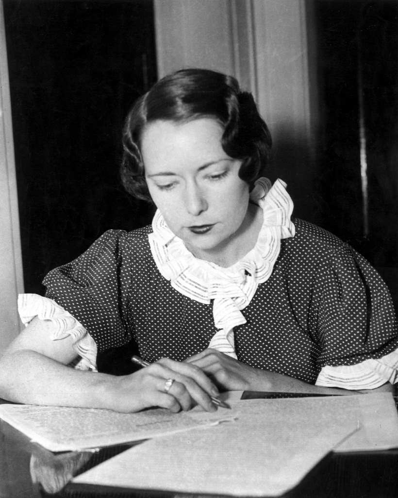 #5 The American writer Margaret Mitchell writing sitting at a table, 1936