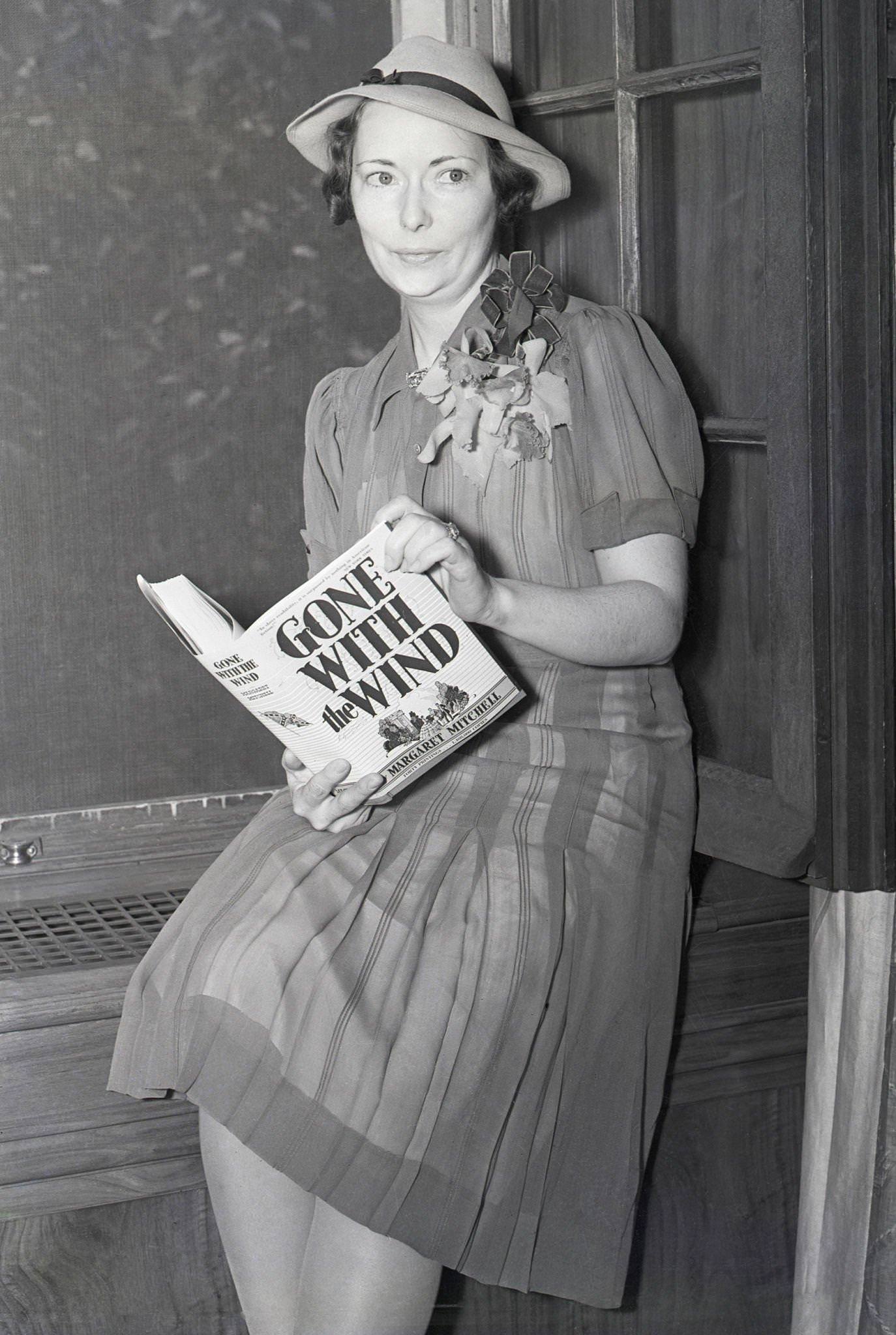 #8 Margaret Mitchell holds a copy of her best-selling novel during her first New York interview at her publishers’ office in 1938.