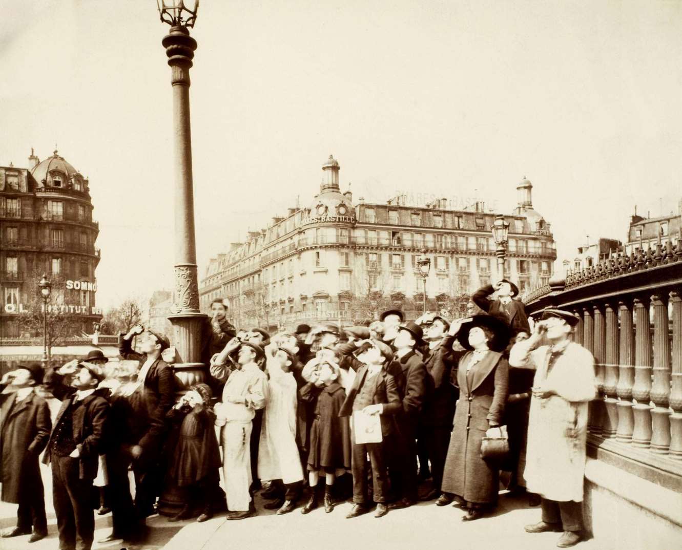 #102 Eugene Atget Solar eclipse of April 17, 1912. Parisians watching the phenomenon from the Place de la Bastille.