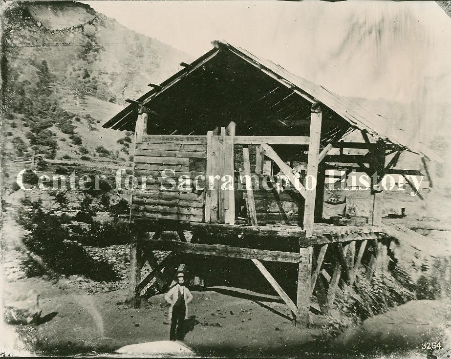 #10 View of man, possibly James Marshall, standing in front of Sutter’s Mill sometime after the discovery of gold, 1850