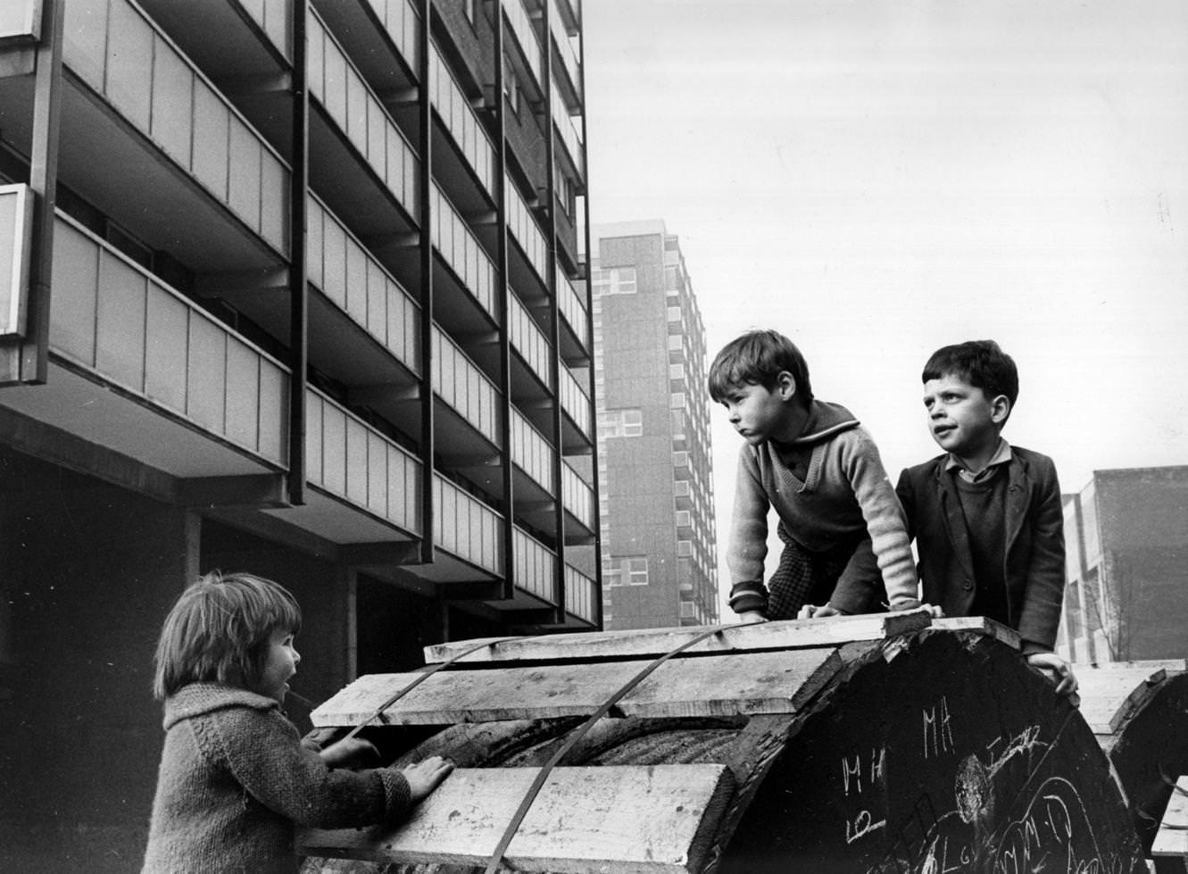 #113 Children playing beside modern tower blocks in the Gorbals area of Glasgow, 1960