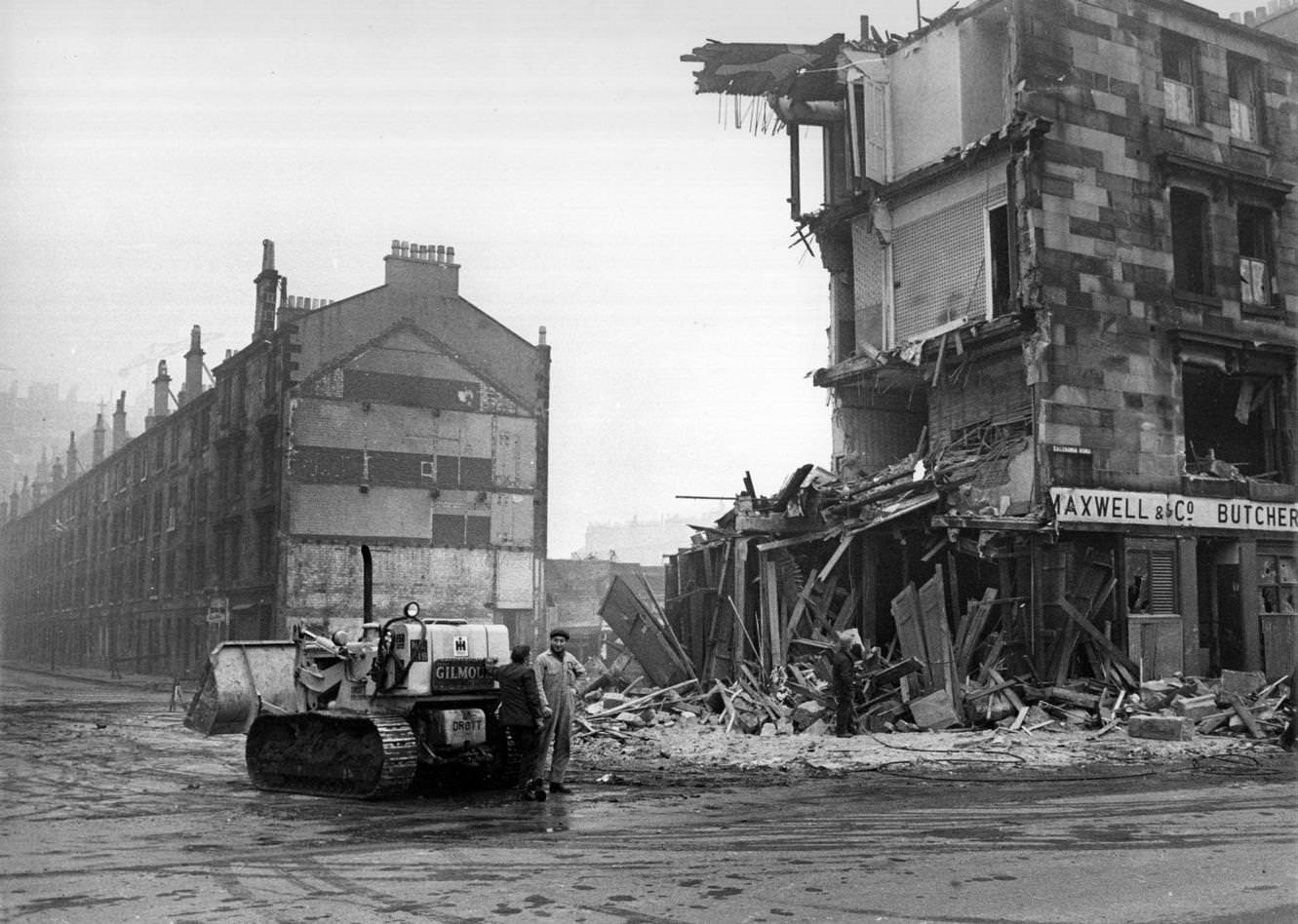 #117 Workmen and a bulldozer beside a tenement being demolished in the Gorbals area of Glasgow, 1960