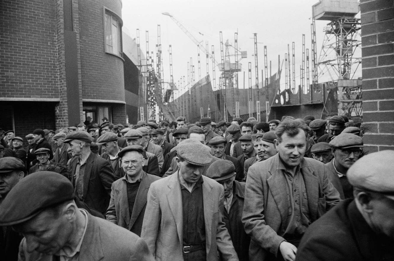 #38 Shipbuilders leaving a shipyard at Greenock on the Clyde, Scotland, 1963.