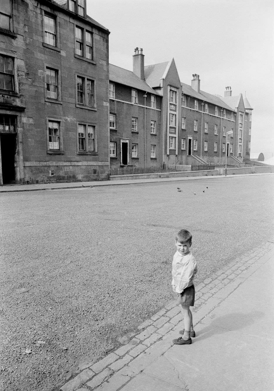 #40 A boy in a street in the shipbuilding town of Greenock on the Clyde, Scotland, 1963.