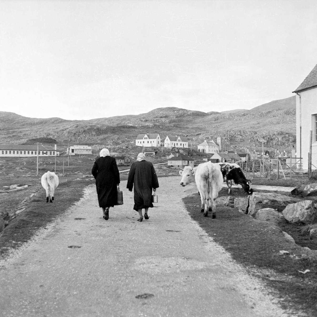 #75 Two women walking on a road on the island of Barra in the Outer Hebrides, 1960