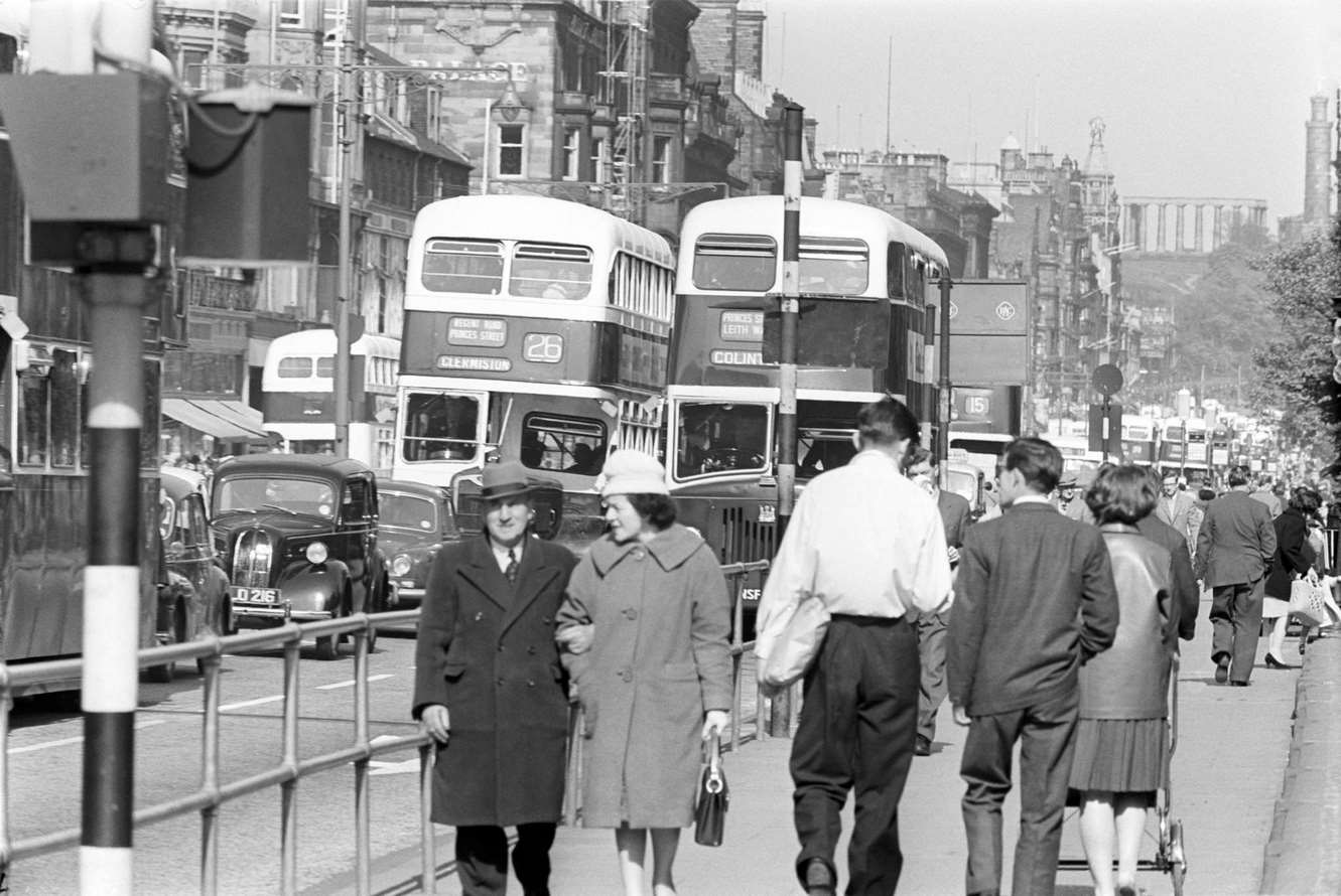 #93 Road traffic in the street; in a close-up, can be seen typical two-level British buses, Scotland, 1964