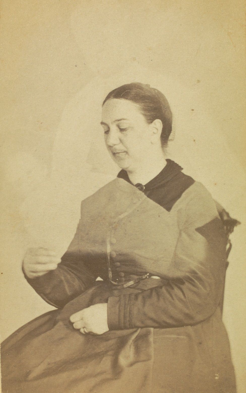 #21 Portrait of Mrs. H.B. Sawyer, looking down at her hand. The faint image of a person is visible above her, with the faint image of a baby across her.