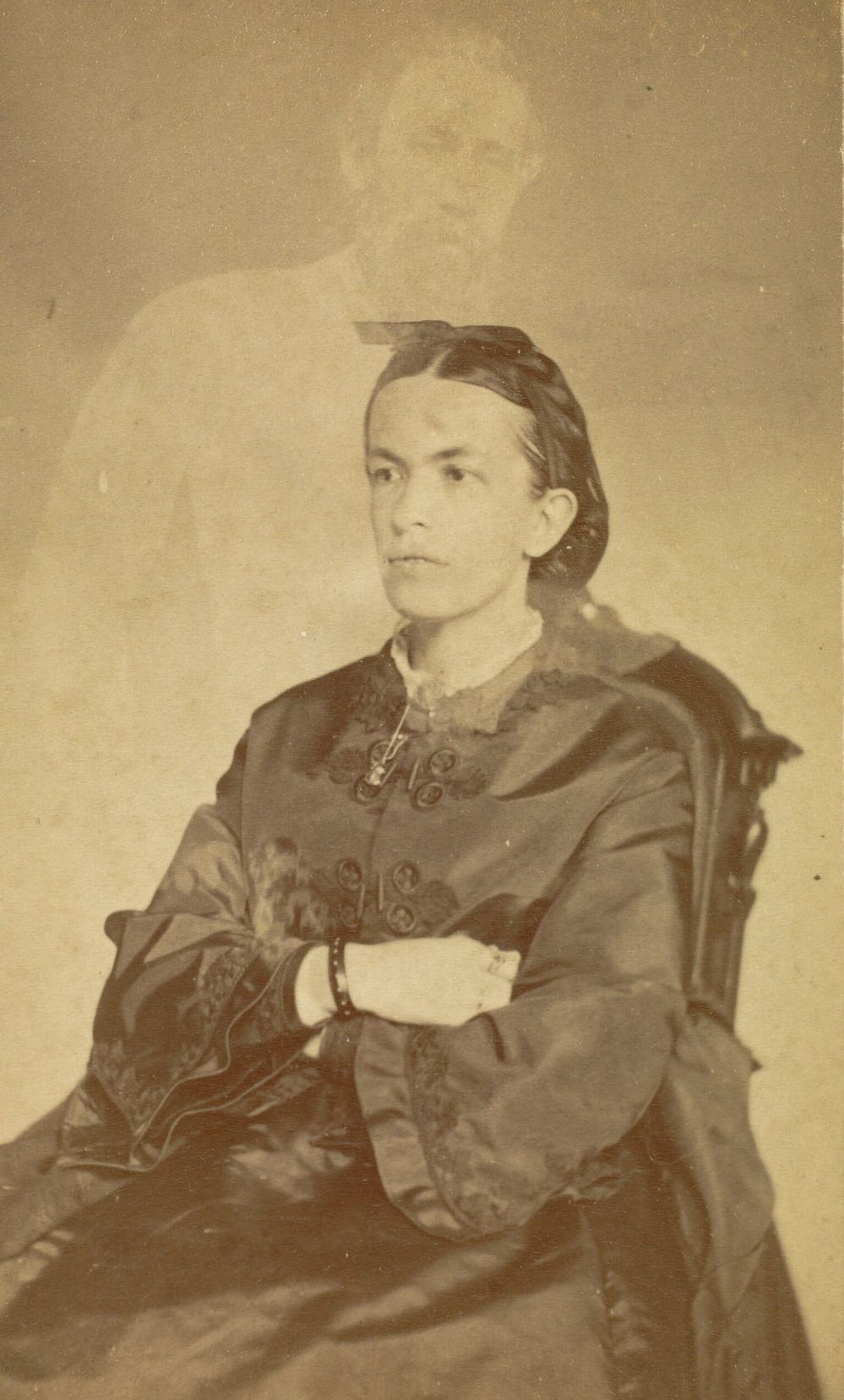 #27 Portrait of Mrs. Conant with her arms crossed. The faint image of a bearded man appears above her.