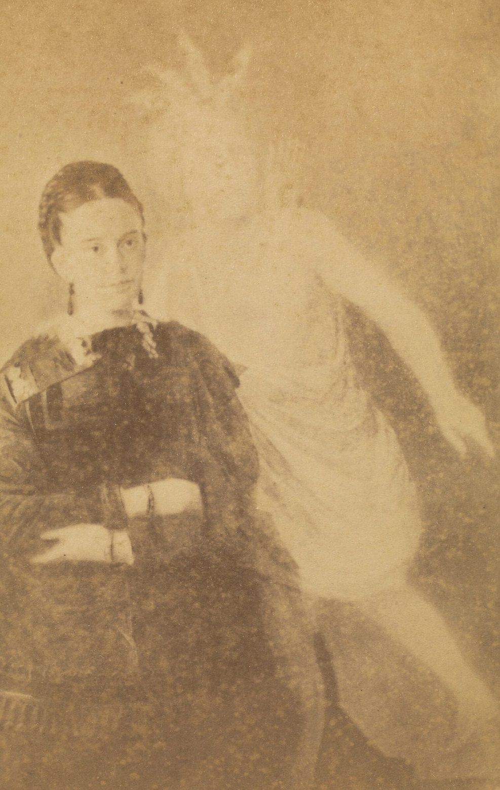 #29 Portrait of Mrs. S.A. Floyd, wearing a dark dress with her arms crossed.