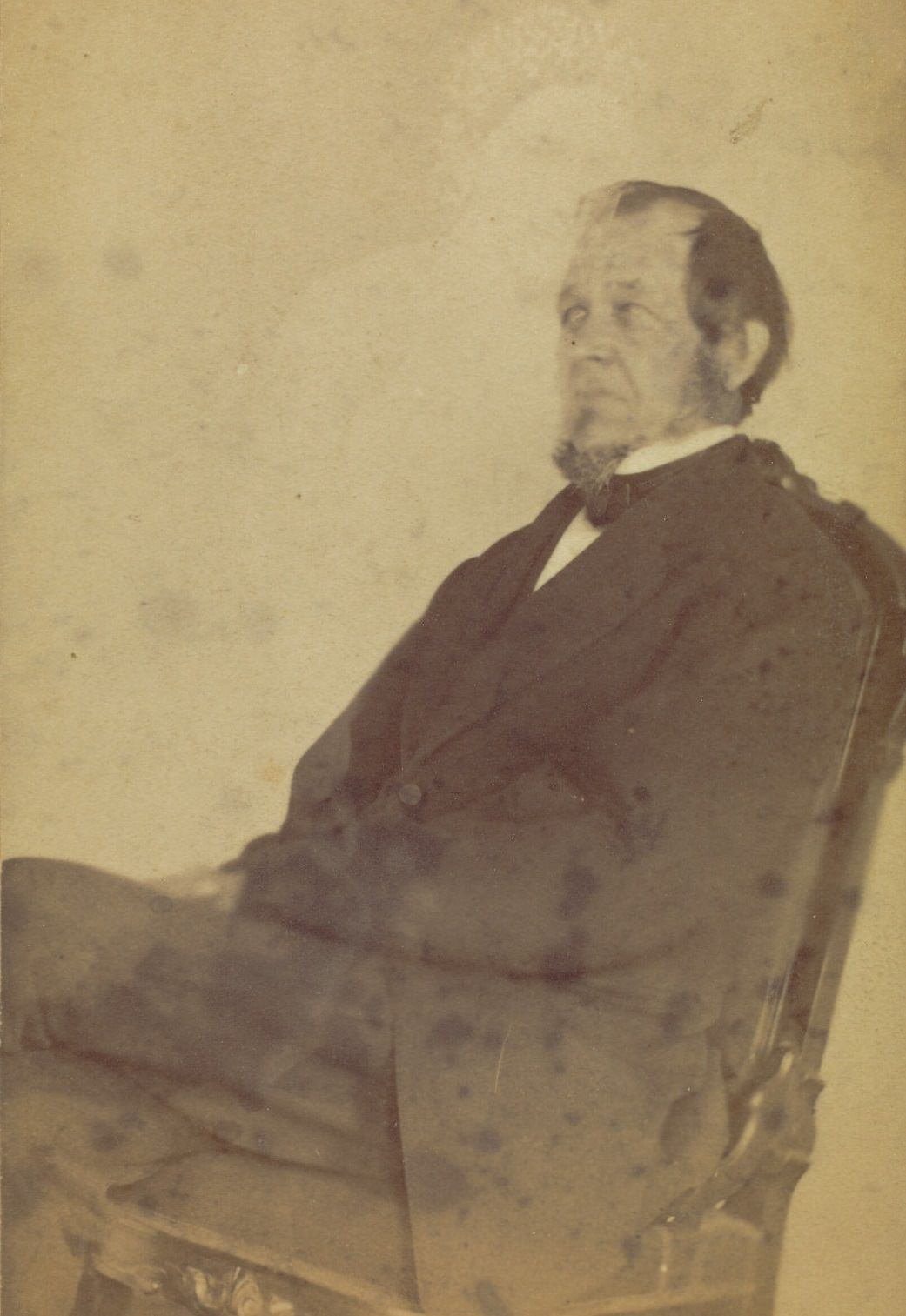 #9 Profile portrait of a seated man with a goatee. A very faint image of a woman is visible above him.