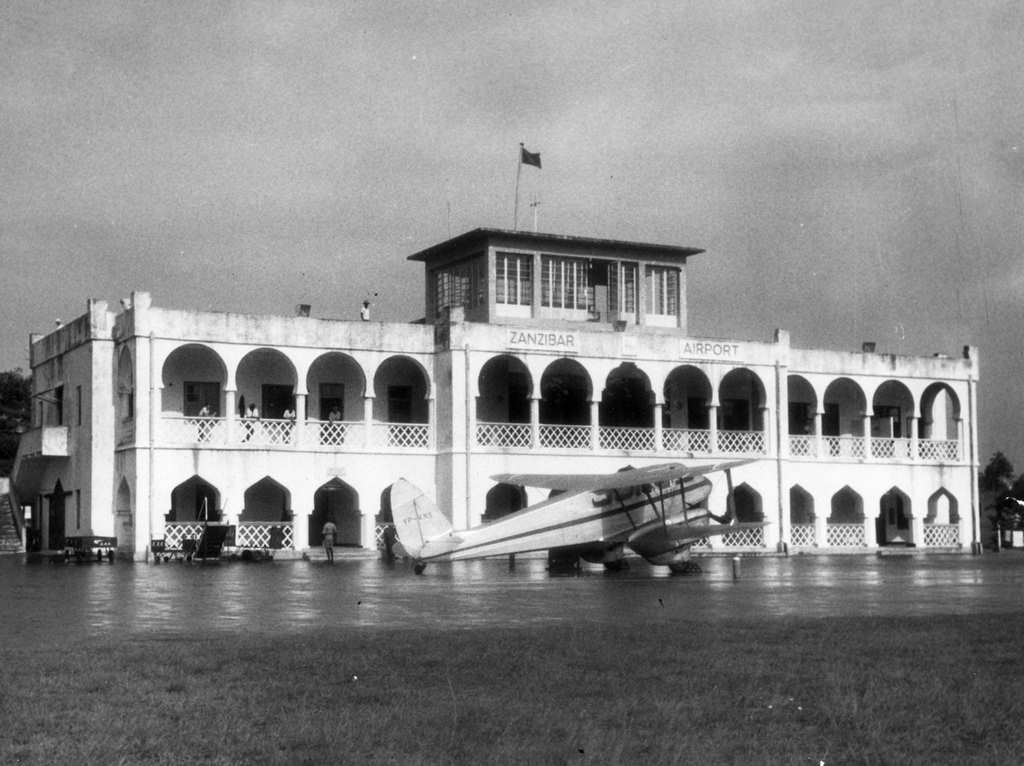 #47 A newly built terminal building at the Zanzibar airport. A five-passenger plane of DH-89-Dominie type connects Daresalam, Zanzibar, Pemba, and Tanga, October 1963.