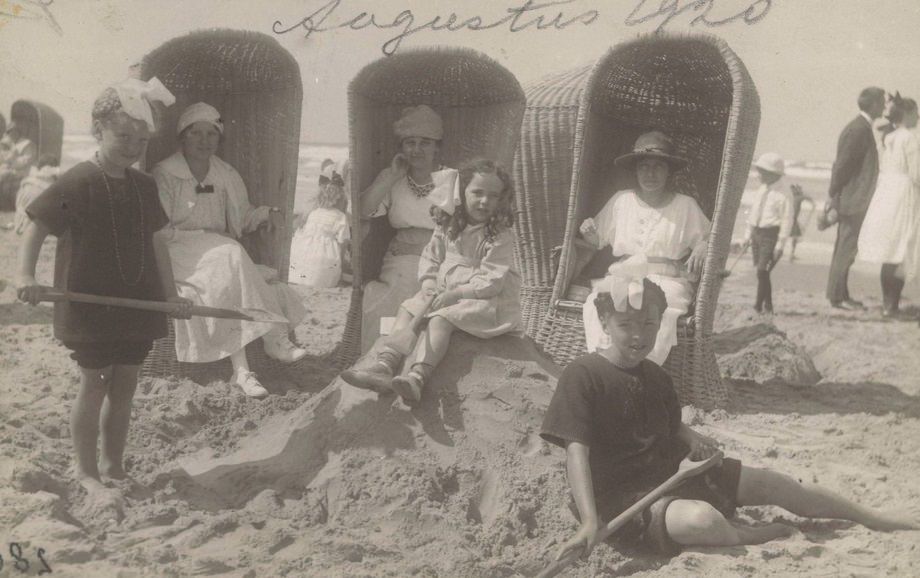 #32 Three women and children in wicker beach chairs on the beach at Wijk aan Zee, 1920