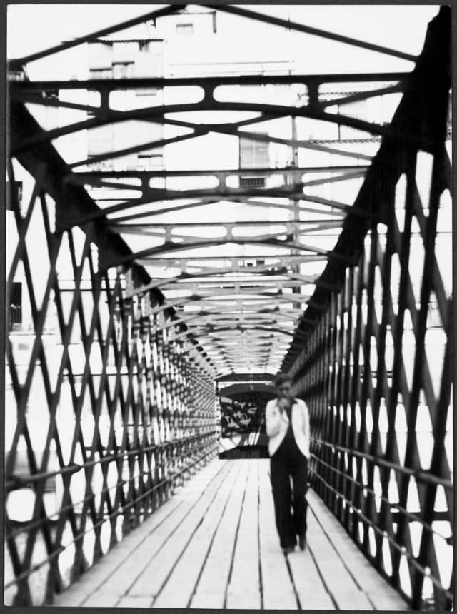 #21 Annemarie Schwarzenbach crossing the Eiffel Bridge over the Onyar river, Girona, 1933