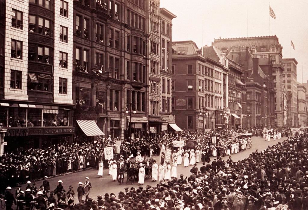 #1 View of a suffrage parade on a city street flanked by a large crowd, 1913
