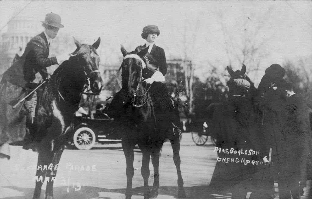 #18 Suffragist, socialite, and artist May Jane Walker Burleson, aka “Jennie” May Burleson, center, mounted on her horse while acting as Grand Marshall for the 1913 Washington, DC suffrage parade