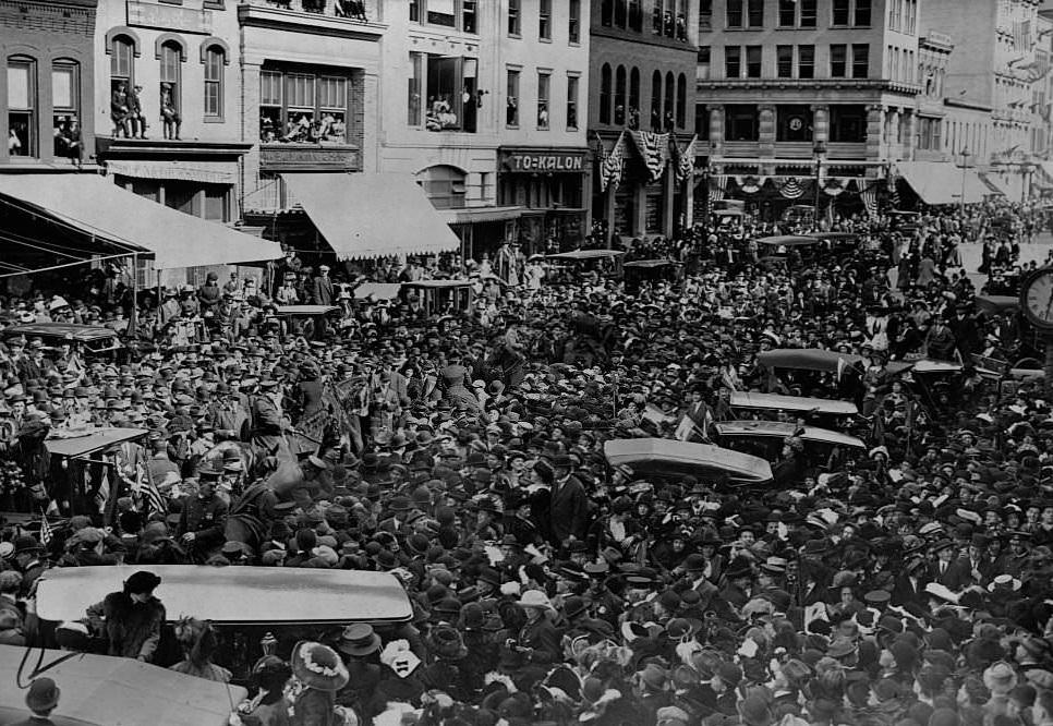 #20 Crowds fill a street in Washington D.C. during a suffrage parade in 1913.