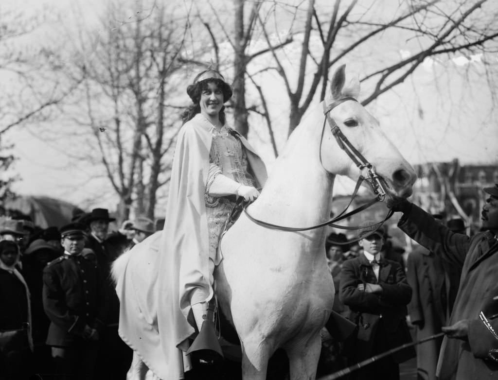 #57 Inez Milholland Boissevain, wearing white cape, seated on white horse at the National American Woman Suffrage Association parade, March 3, 1913