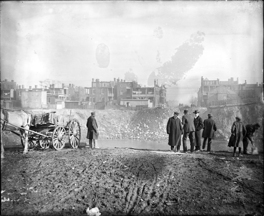 #151 Large pit in the middle of an urban area that is filled with water, 1908.