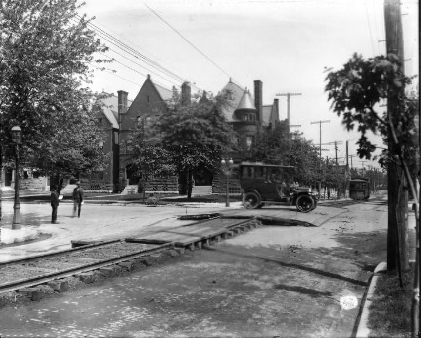 #163 Automobile crossing streetcar tracks over wooden road crossing, 1909