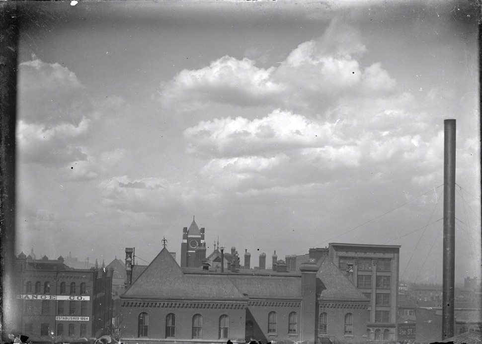 #244 A City View with a Smokestack, 1903. Several other buildings with a cloudy sky, and a smokestack on the right side of the image.