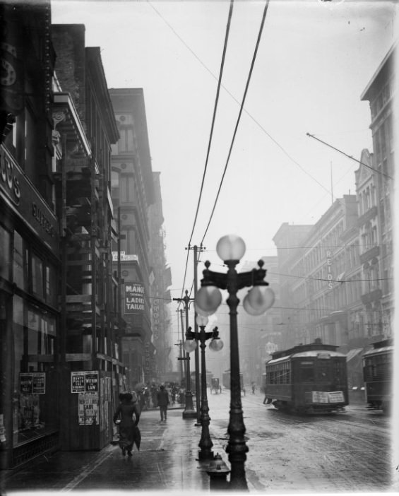 #78 Rainy city street with street lamps visible in the foreground, 1901