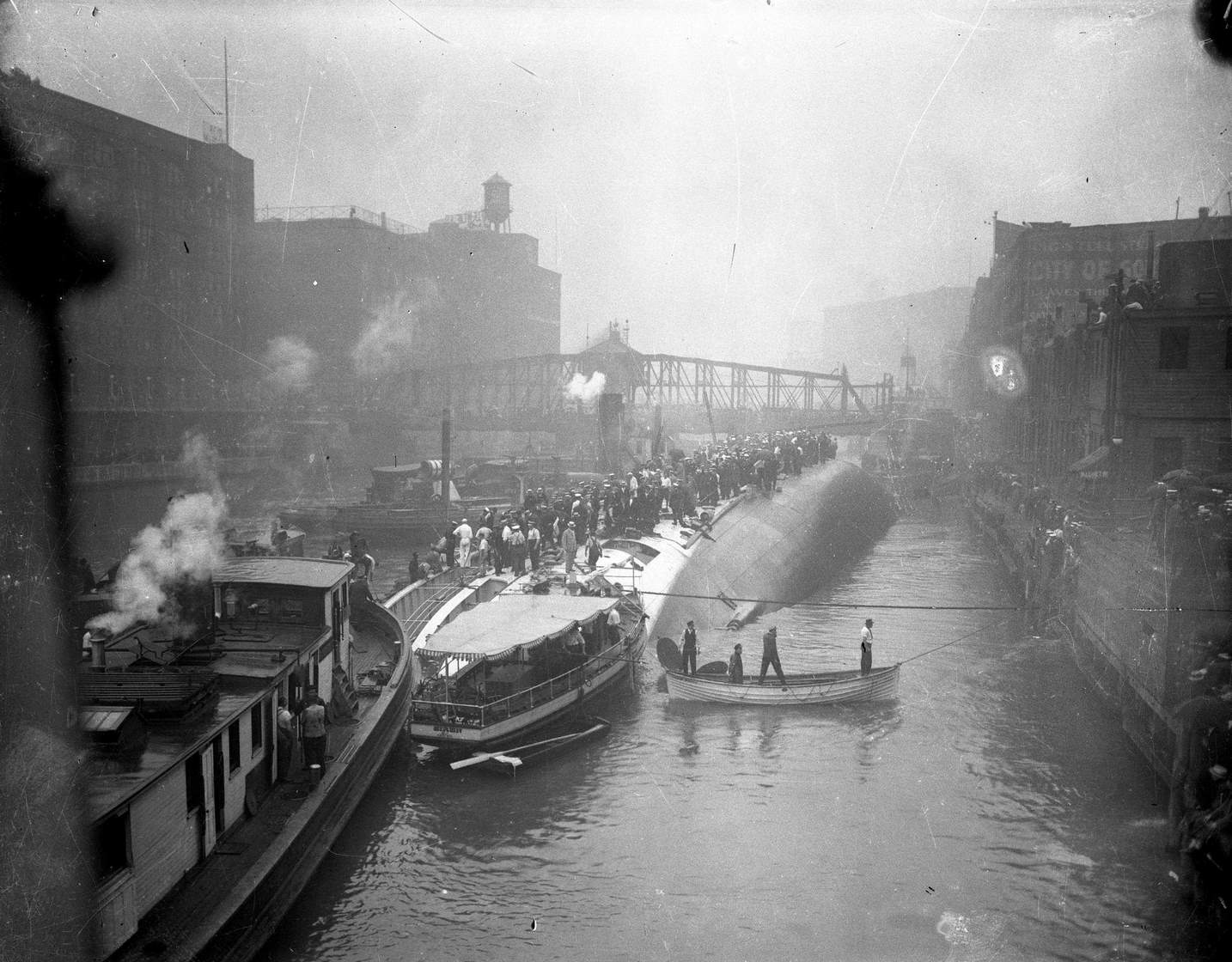 #94 The S.S. Eastland lying on its side in the Chicago River after slowly rolling over and drowning 844 people on July 24, 1915 in Chicago.