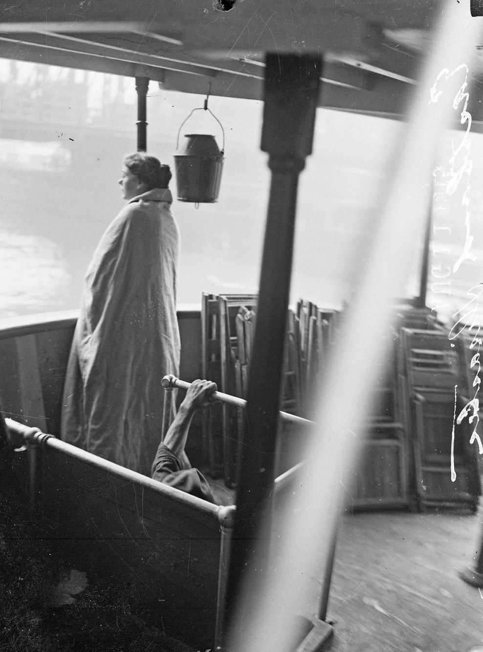 #95 Eastland disaster, female survivor, wrapped in a blanket, standing on upper deck of a boat, Chicago, Illinois, July 24, 1915.