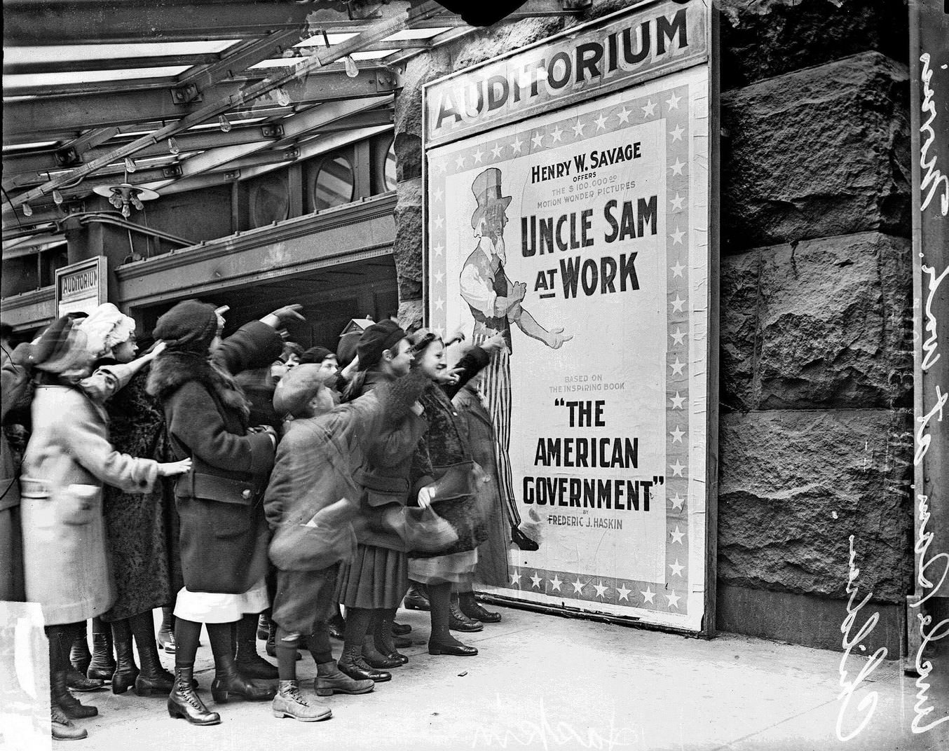 #109 Children pointing at a movie poster for Uncle Sam at Work at the Auditorium Theater, Chicago, Illinois, February 20, 1915.