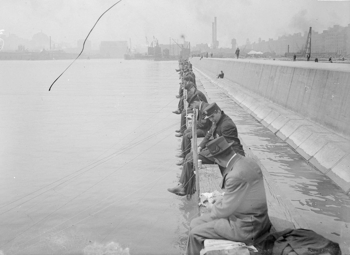#130 Men fishing from North Pier, sitting along a breakwater at the mouth of the Chicago River, Chicago, Illinois, 1910s.