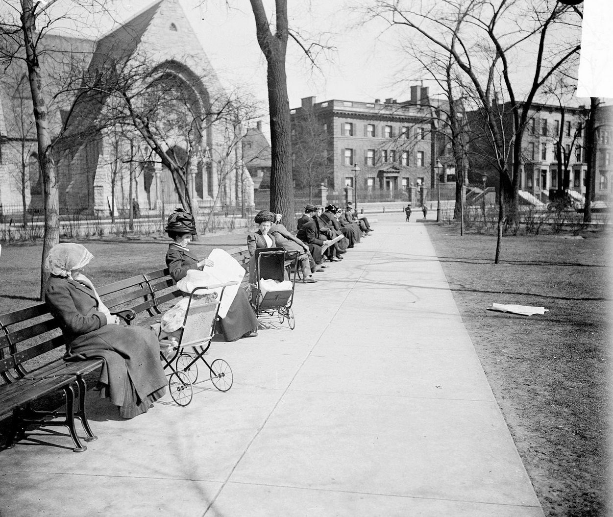#132 People sitting on benches along a pathway through Washington Square Park in Spring in the Near North Side community area, Chicago, Illinois, 1910s.