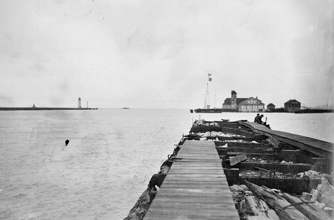 #152 Mouth of Chicago River looking along a pier toward a US Life Saving station on Lake Michigan, Chicago, Illinois, 1910s.
