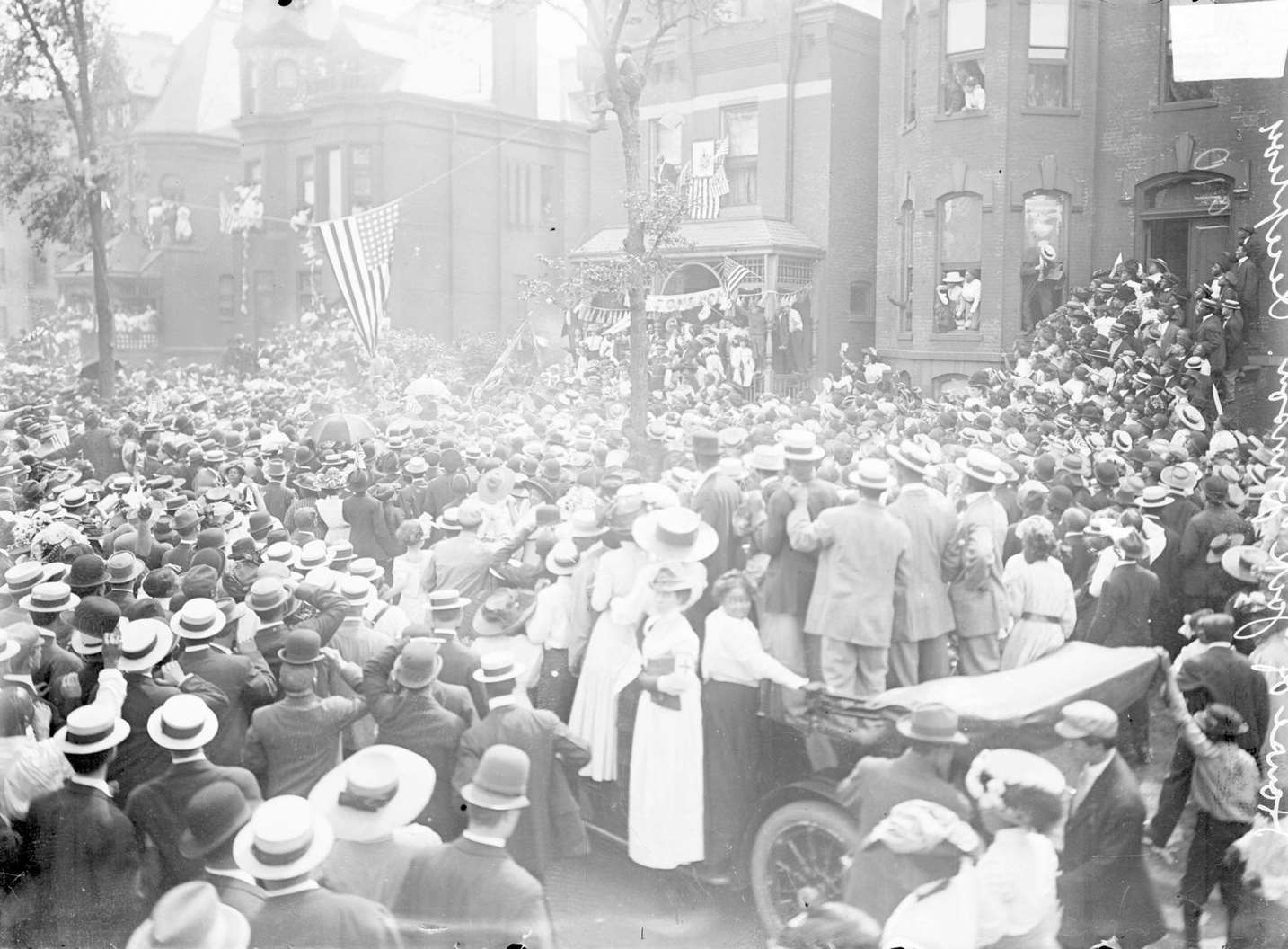 #166 A large crowd of people gathering on the street in front of a house where Jack Johnson’s reception was taking place in Chicago, 1910.