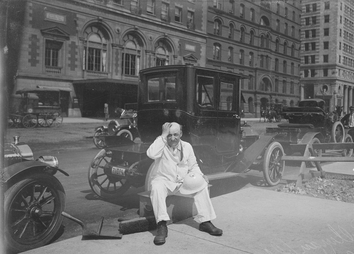 #44 City of Chicago street sweeper on a hot day, sitting on a trash can on Michigan Avenue, across from Orchestra Hall, Chicago, Illinois, 1911.