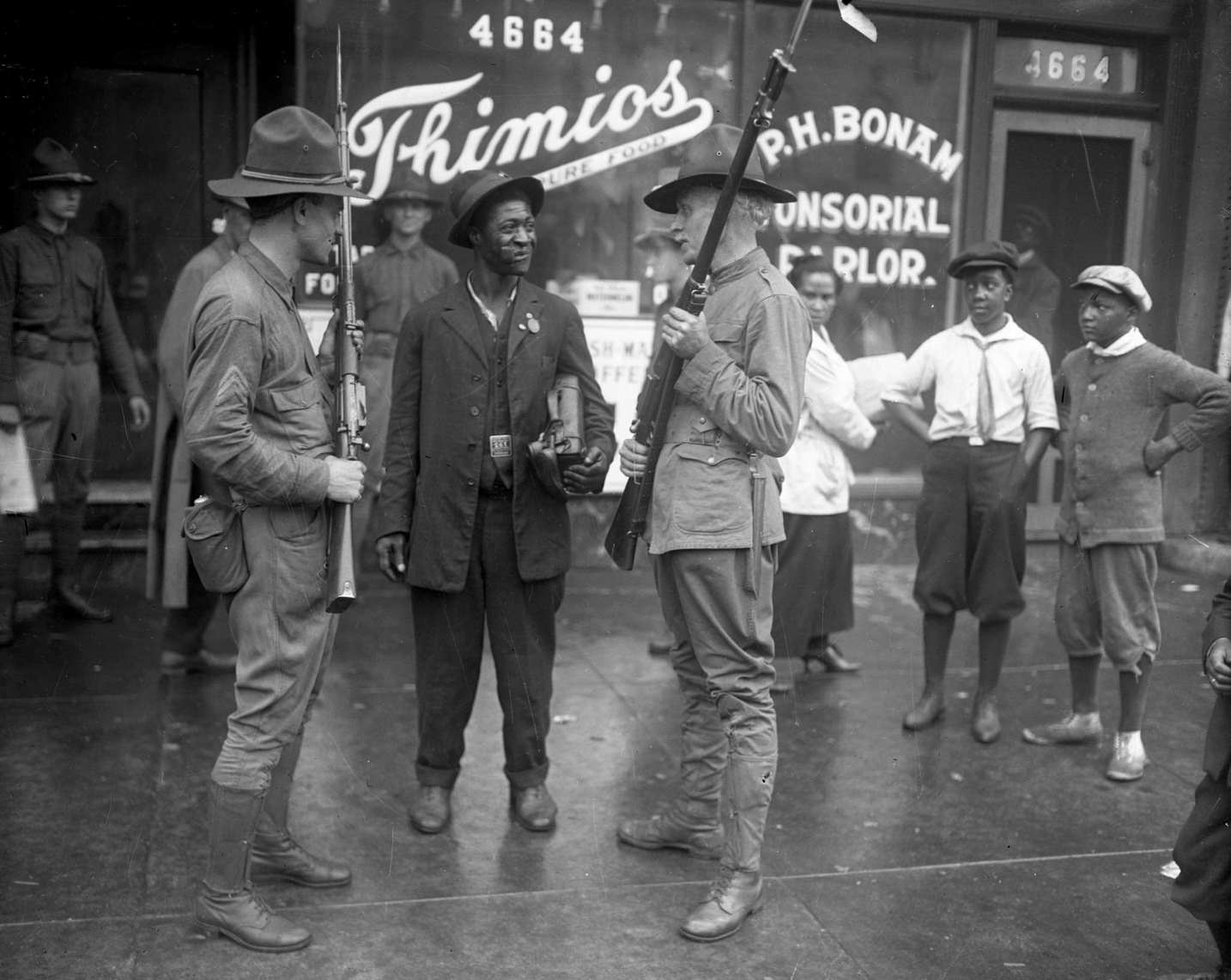 #47 Members of the state militia talk with a man during the Chicago race riots of 1919.
