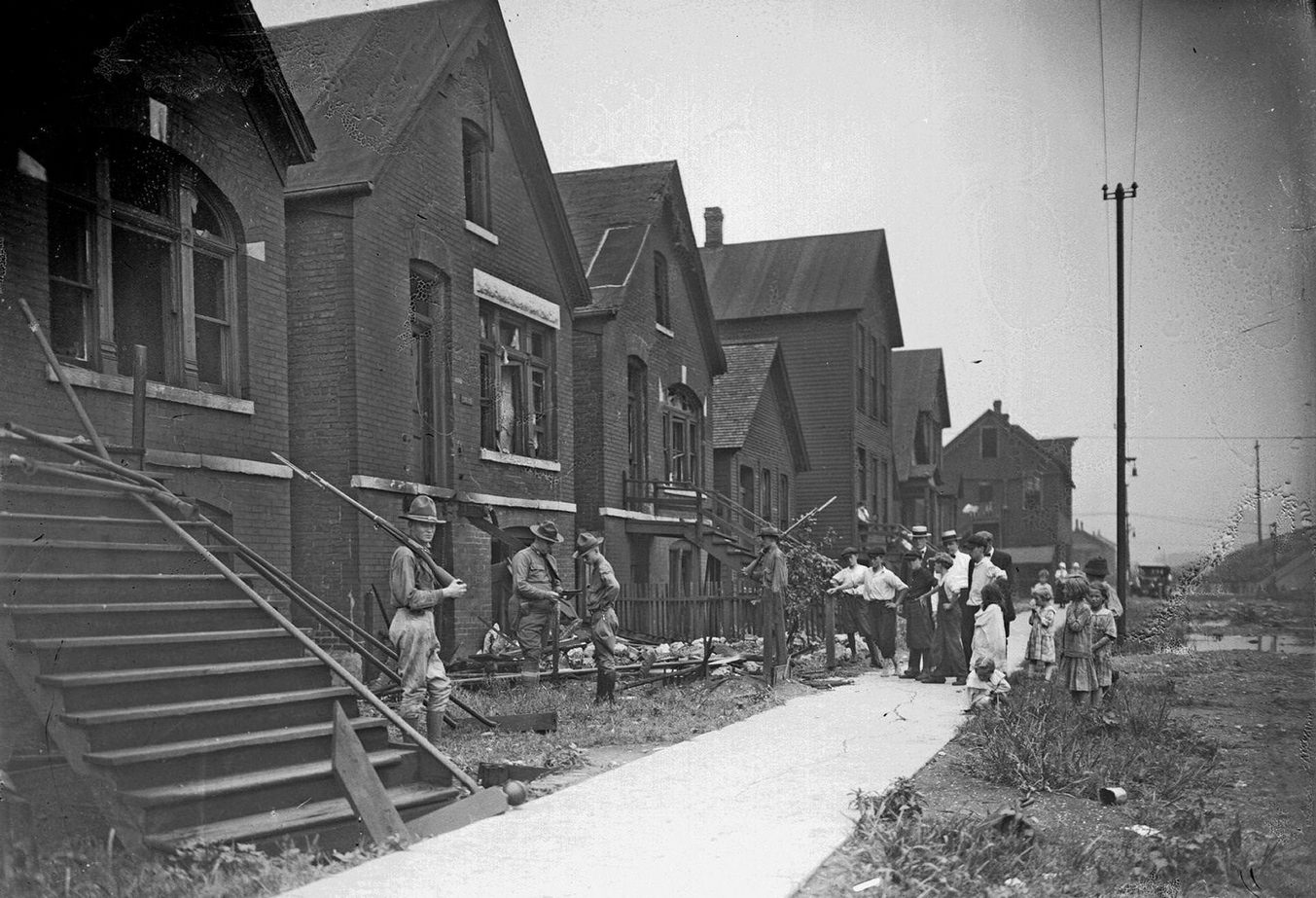 #50 Chicago race riot, soldiers with rifles standing guard at vandalized house, Chicago, Illinois, July 30, 1919.